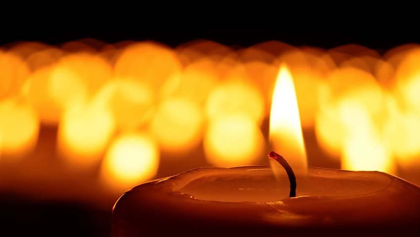 A lit candle representing spiritual reflection and soul retrieval