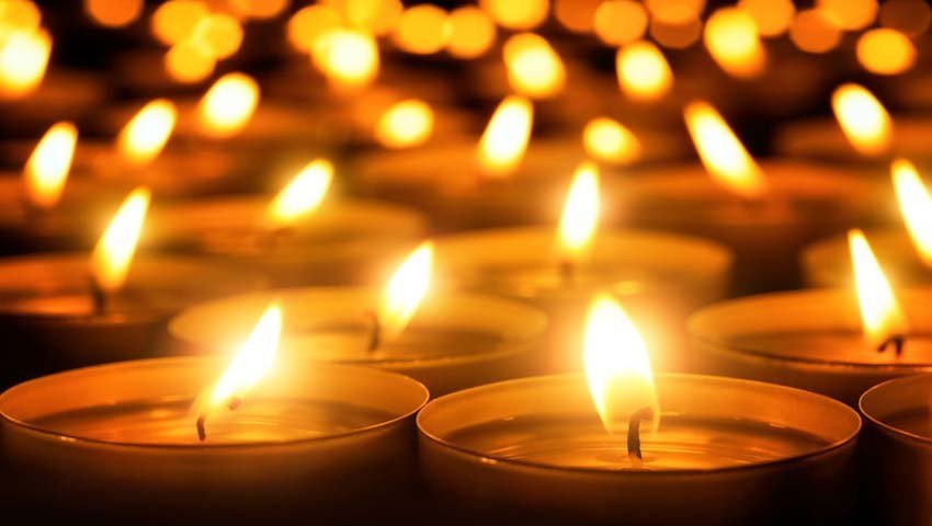 A lit candle representing quiet reflection and gratitude