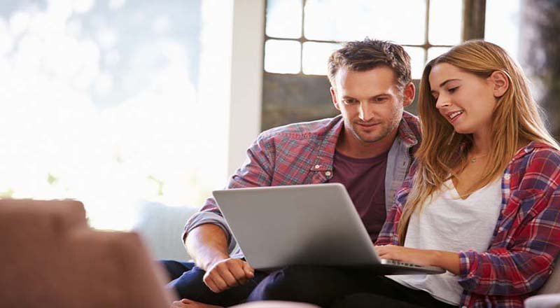 Man having an online counselling session by video call on a laptop